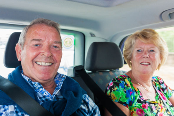 Elderly couple in taxi